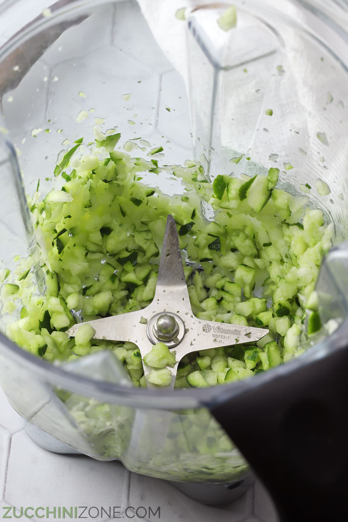 Chopped zucchini in a blender.