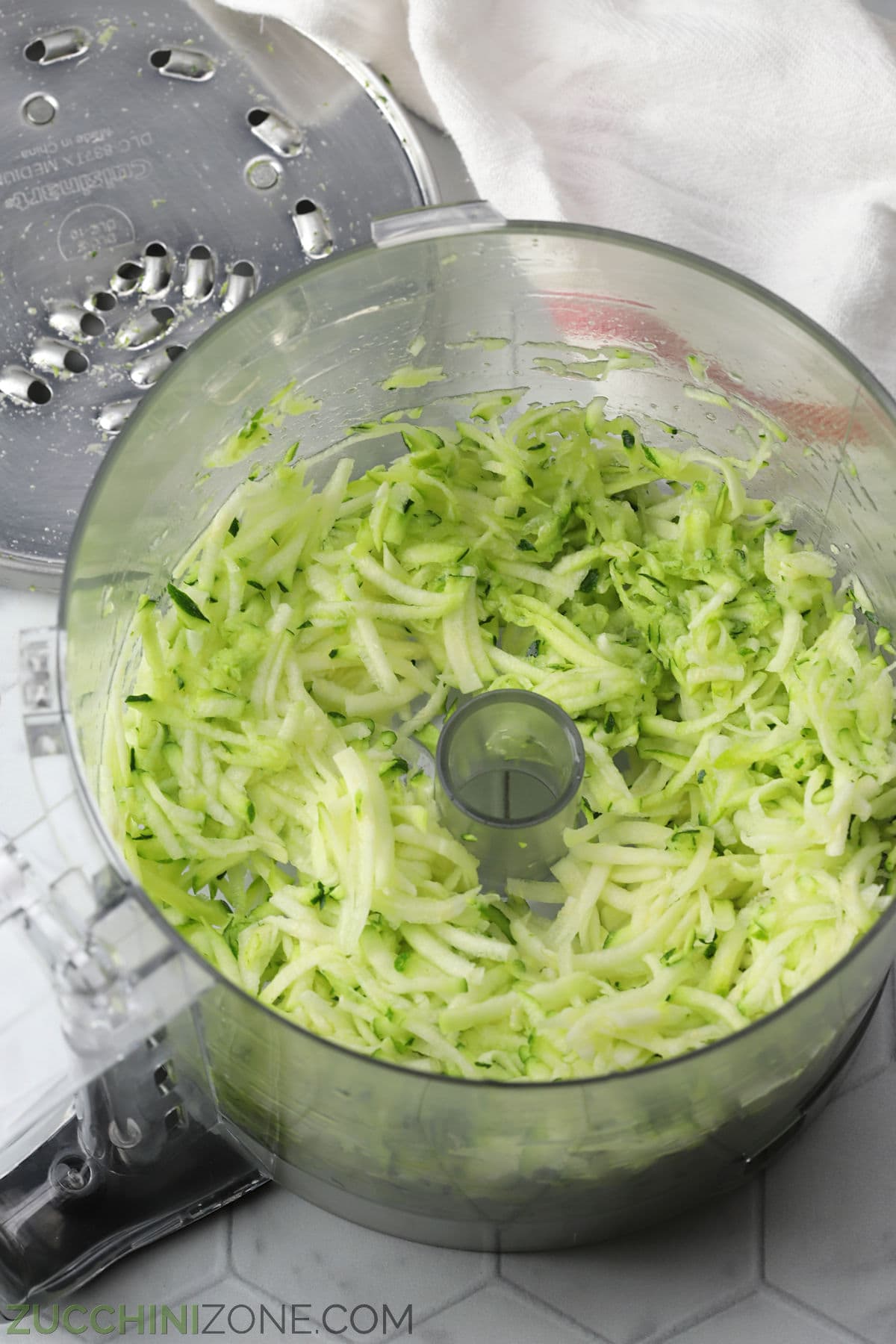 Grated zucchini in a food processor.