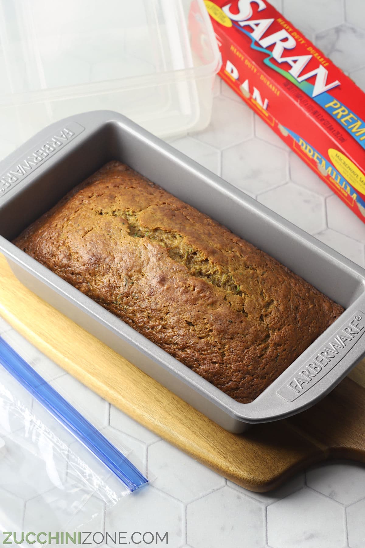 Metal loaf pan with zucchini bread.