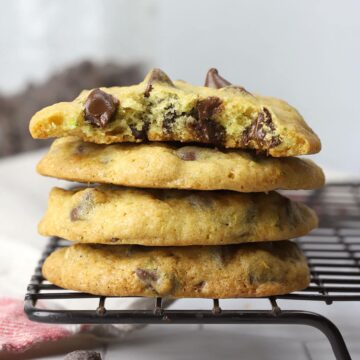 A stack of zucchini chocolate chip cookies on a cooling rack.