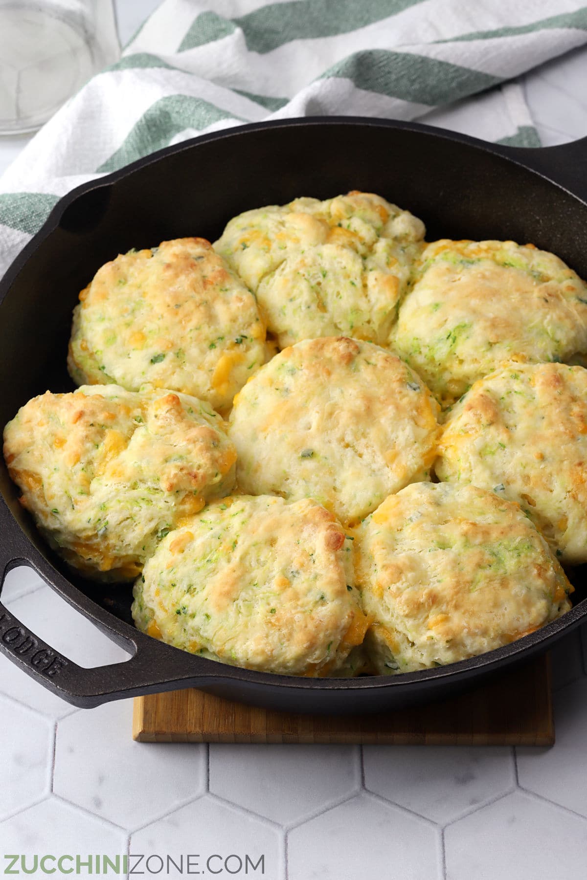Cast iron skillet filled with baked zucchini cheddar biscuits.