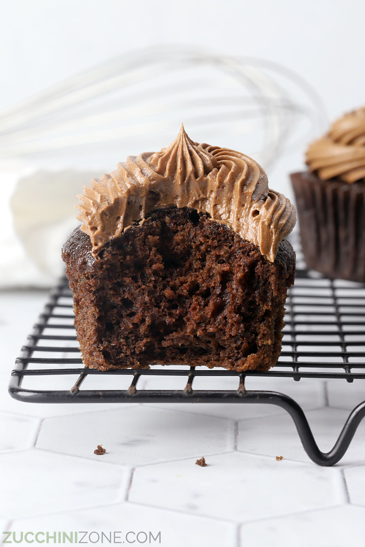 Chocolate zucchini cupcake with a bite missing.