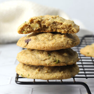A stack of zucchini cookies on a cooling rack.