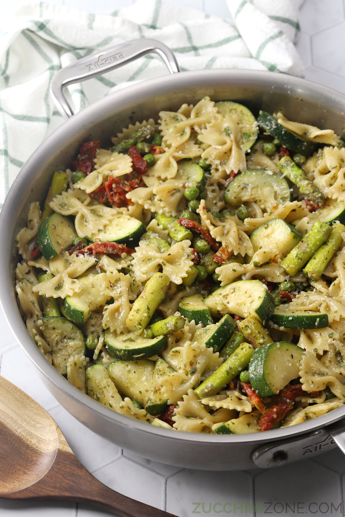 A sauté pan filled with pesto primavera. 