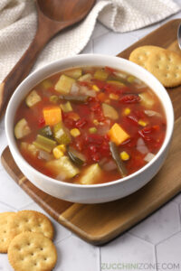 A white bowl filled with slow cooker vegetable soup.