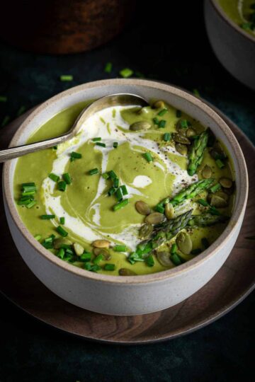 A bowl of creamy broccoli and asparagus soup.