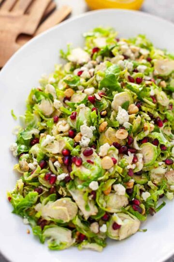 A white bowl of Brussels sprout salad.