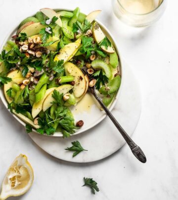 A white bowl of celery and apple salad.