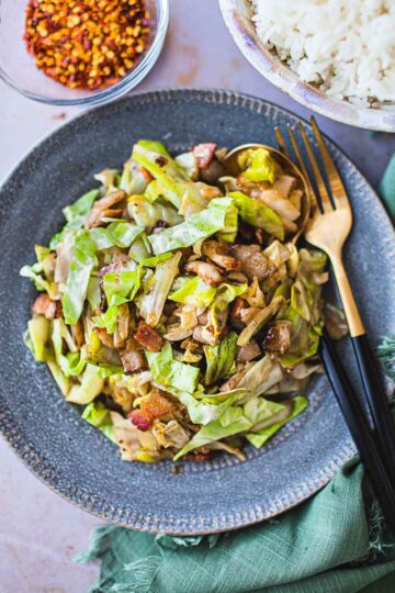 A blue plate of stir fried cabbage.