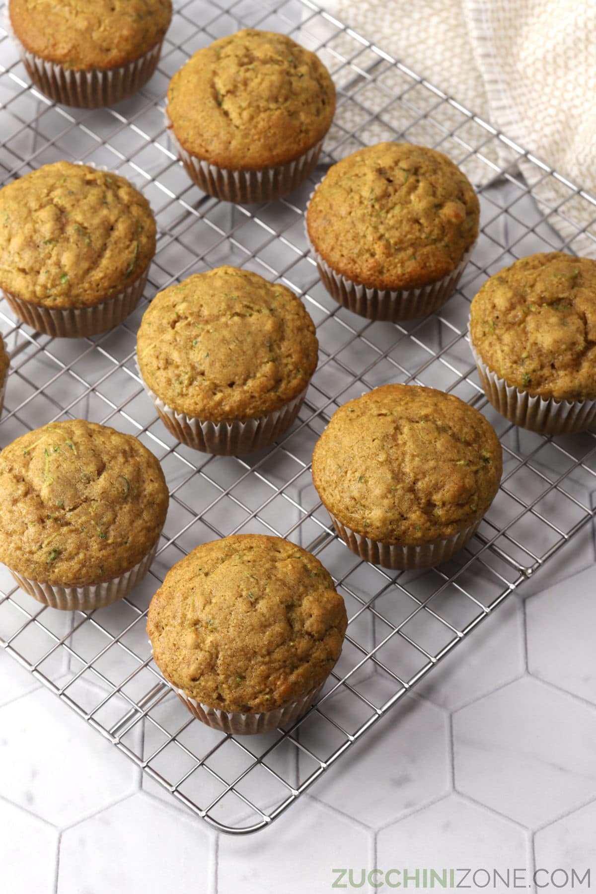 Muffins lined up on a cooling rack.