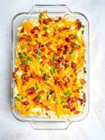 A glass baking dish of twice baked potatoes.