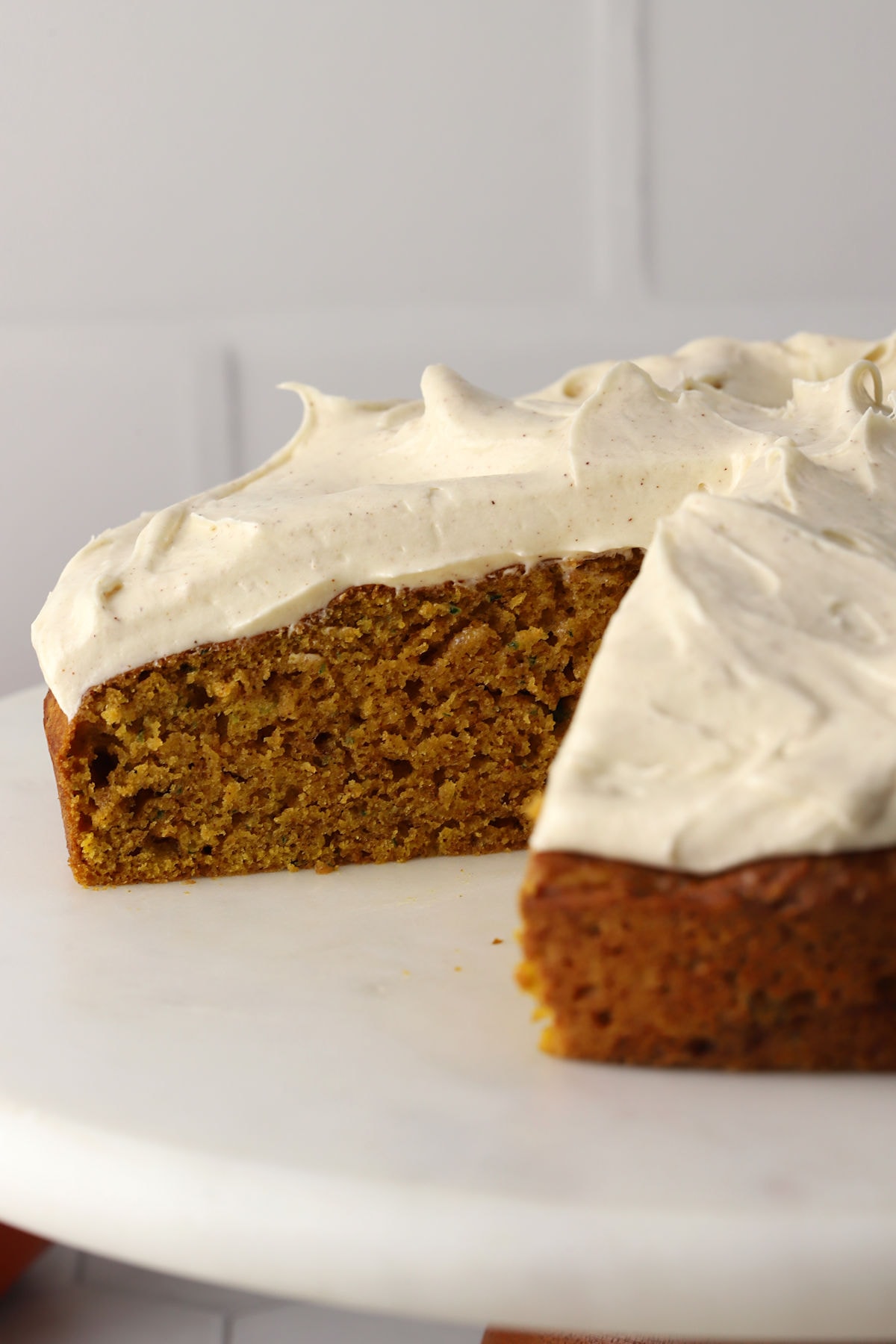 A frosted cake with a slice missing.