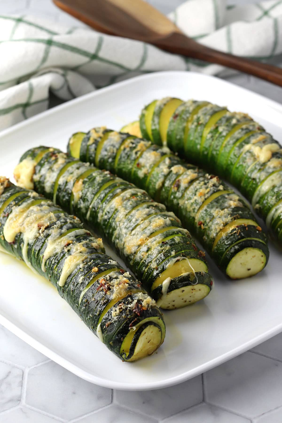 Hasselback zucchini on a platter.