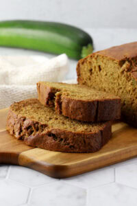 Slices of zucchini bread on a cutting board.