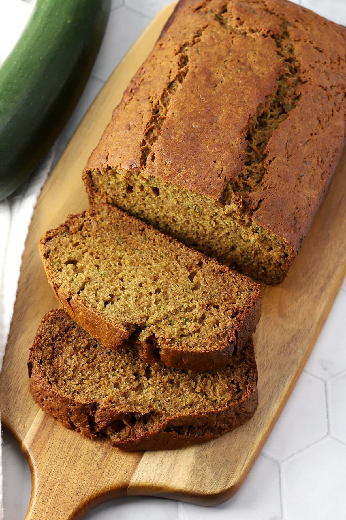 A loaf of zucchini bread on a cutting board.