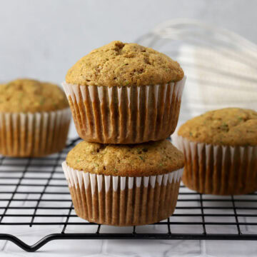 A stack of muffins on a cooling rack.