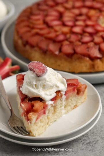 A slice of rhubarb upside down cake with whipped cream.