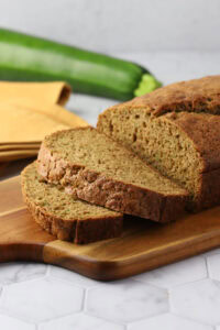 Slices of zucchini bread on a cutting board.