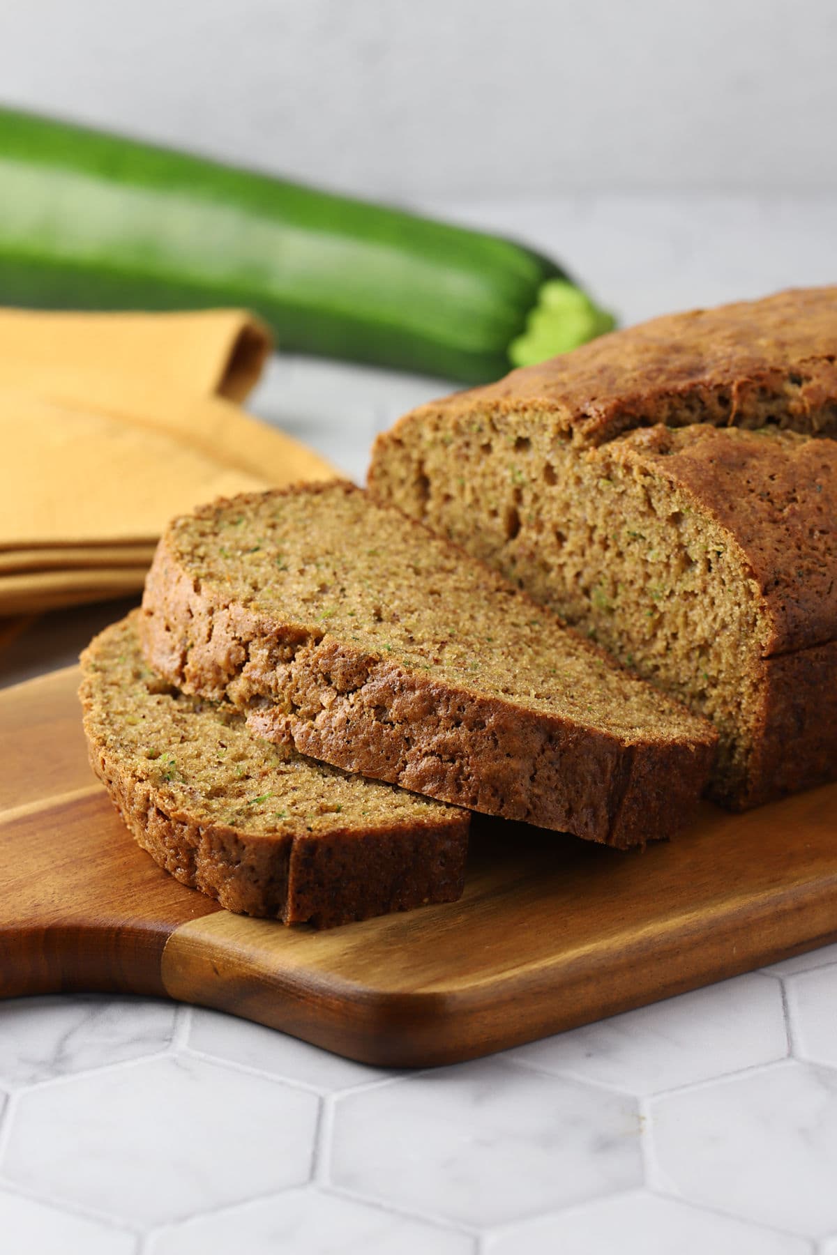 Slices of zucchini bread on a cutting board.