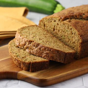 Slices of zucchini bread on a cutting board.